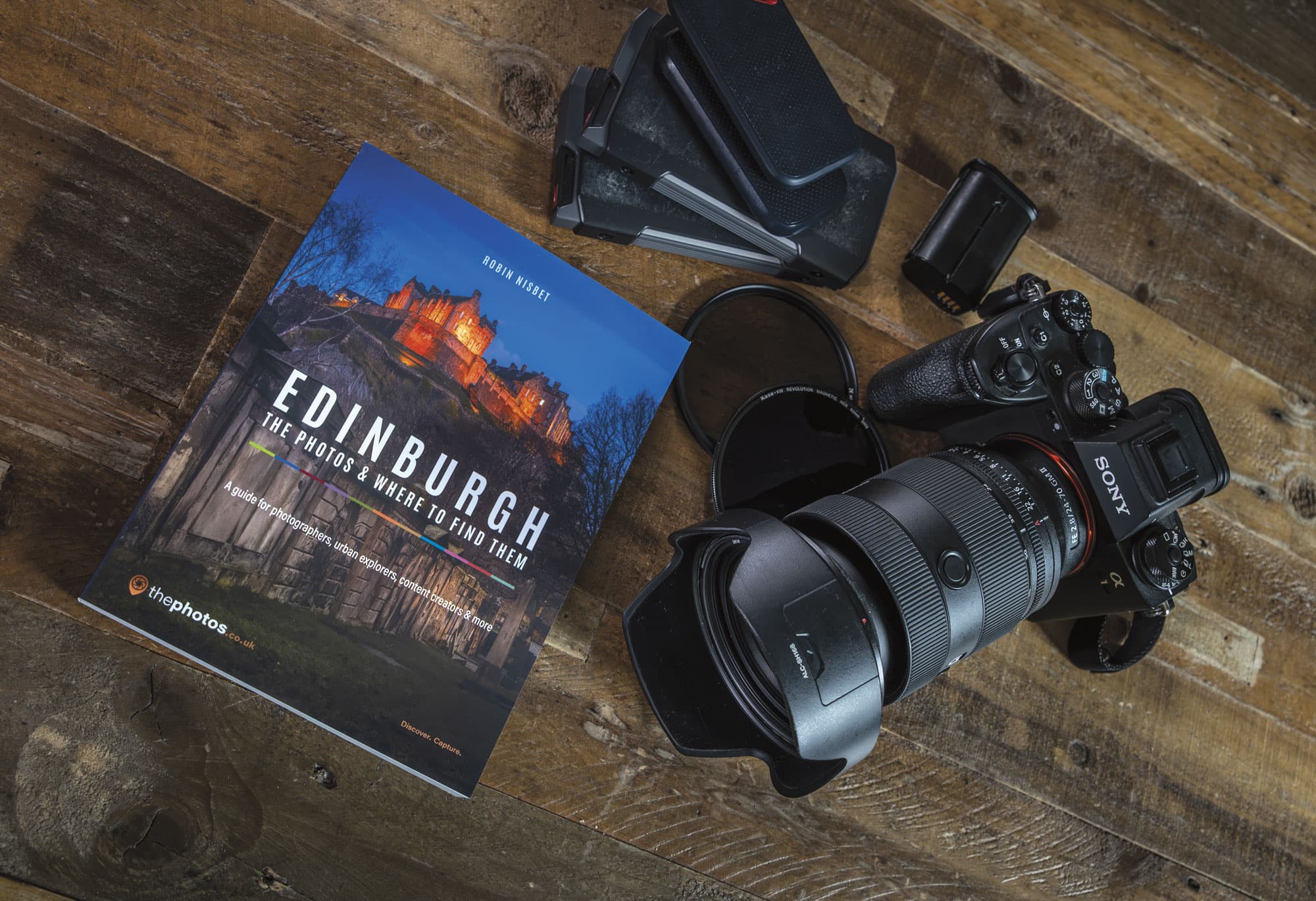 Edinburgh: The Photos & Where to Find Them on a wooden table beside a camera, lens and filters